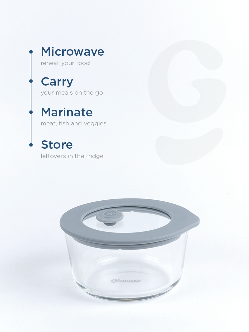 Glass food storage container with gray lid on a white background